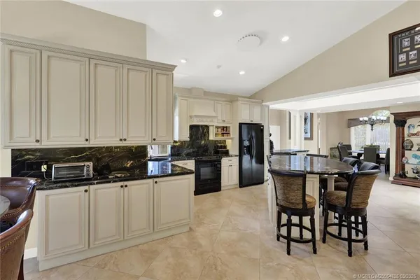 a dining room with furniture large window and wooden floor