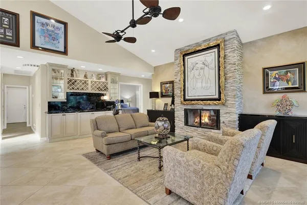 a living room with furniture and kitchen view