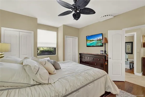 a bedroom with a bed couches and a large window with outer view