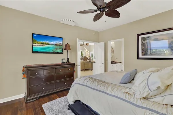 a bedroom with a bed and a painting on the wall