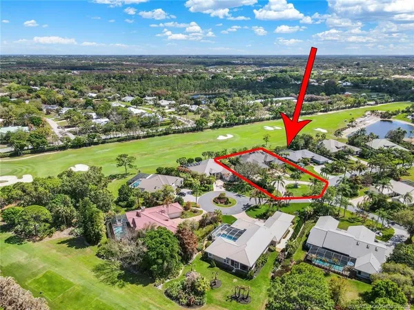 an aerial view of residential houses with outdoor space and swimming pool