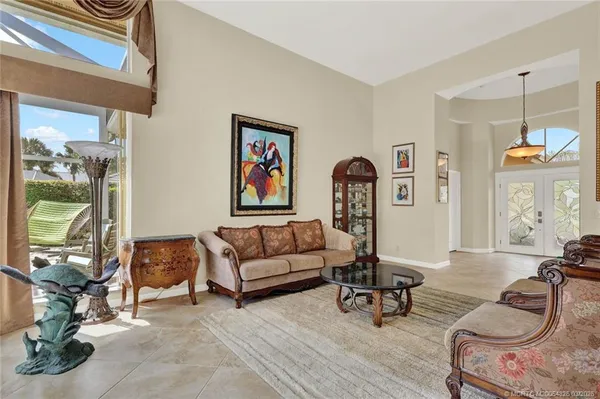 a living room with furniture a fireplace and a large mirror