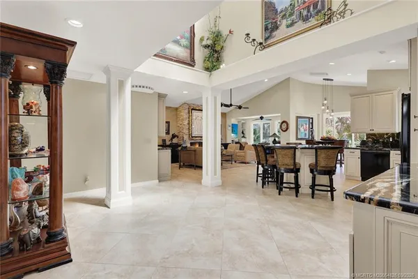 a kitchen with stainless steel appliances kitchen island granite countertop a refrigerator and a stove top oven