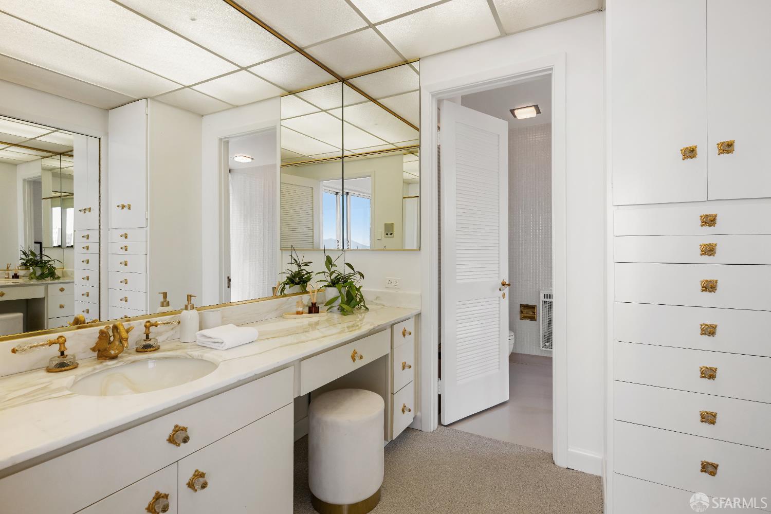 1750 Taylor Street, Unit 1001 San Francisco, CA 94133 - Photo 21 of 43 a bathroom with a granite countertop sink mirror and double