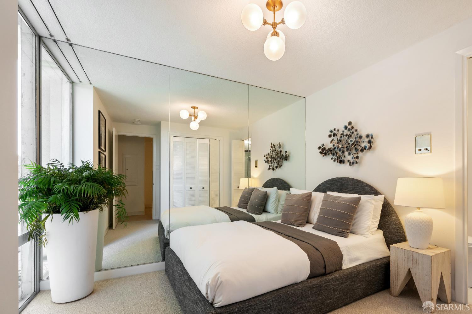 1750 Taylor Street, Unit 1001 San Francisco, CA 94133 - Photo 25 of 43 a bedroom with a large bed and a chandelier