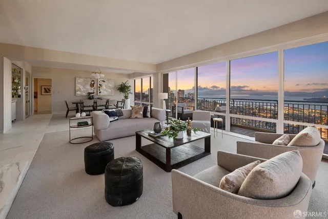 a living room with furniture and a floor to ceiling window