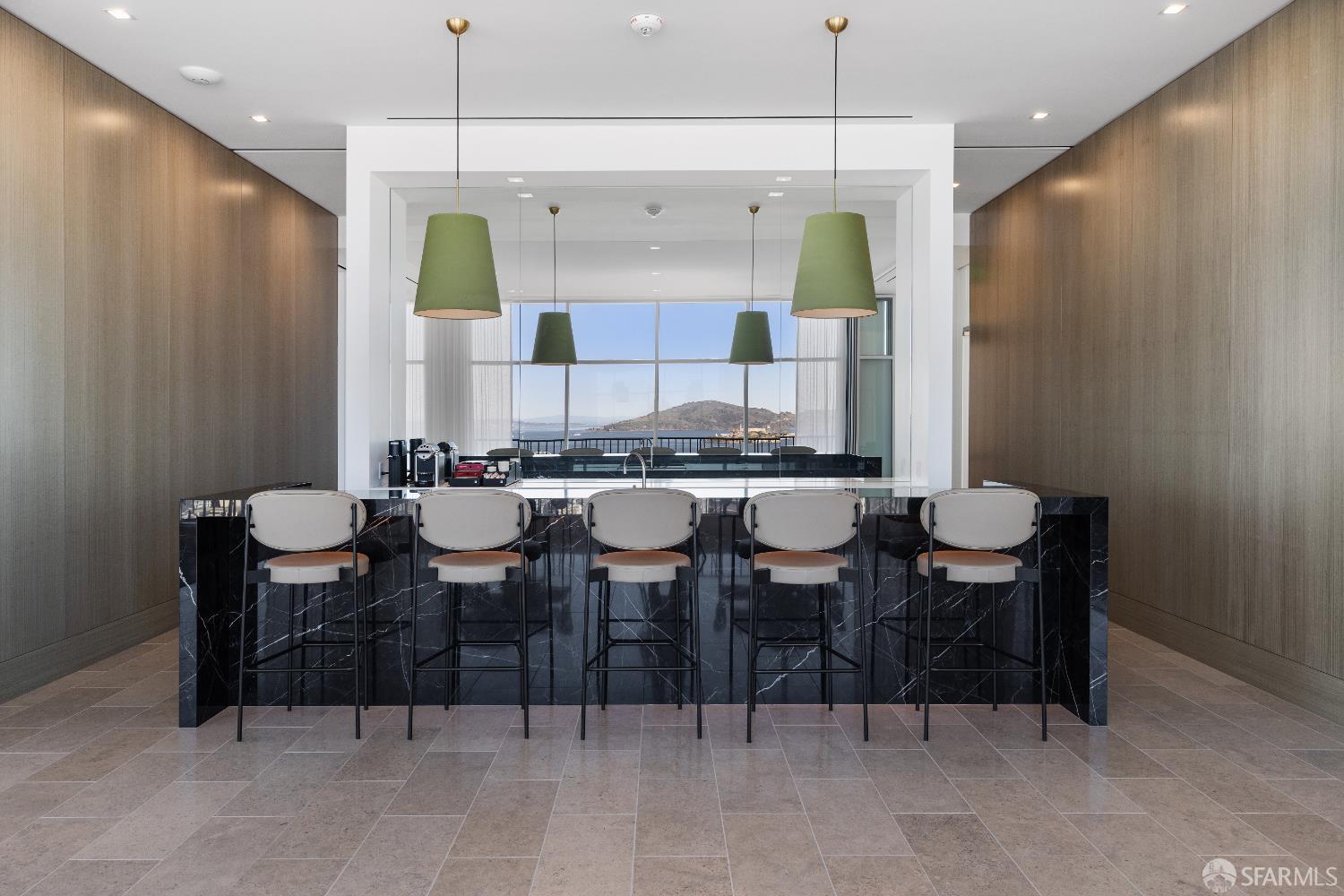1750 Taylor Street, Unit 1001 San Francisco, CA 94133 - Photo 34 of 43 a kitchen with a dining table chairs and white cabinets