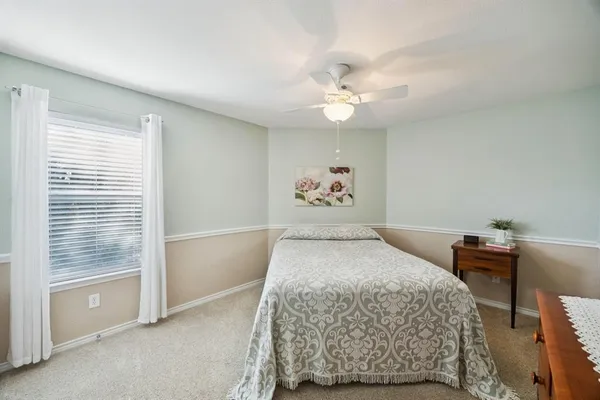 a bedroom with a large bed and a chandelier