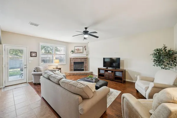 a living room with furniture flat screen tv and a fireplace