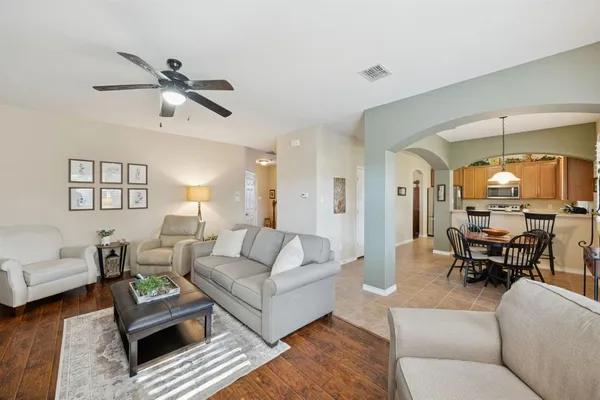 a living room with furniture and a wooden floor