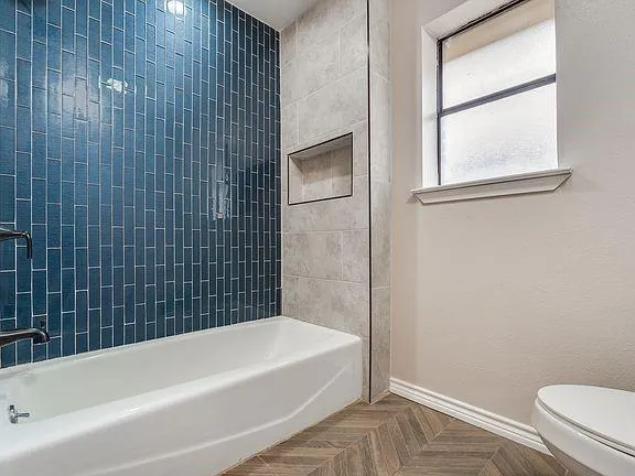 a bathroom with a bathtub and a toilet