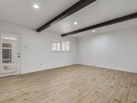 a view of an empty room with windows