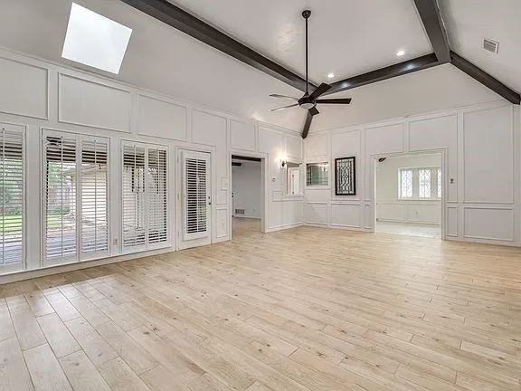 a view of a livingroom with a fireplace a chandelier and stairs