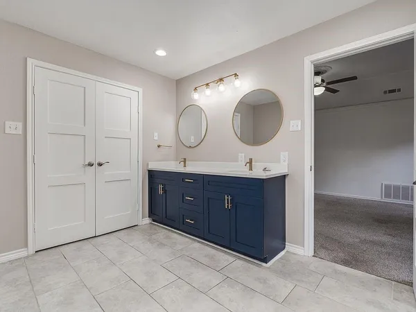 a bathroom with a double vanity sink and a mirror