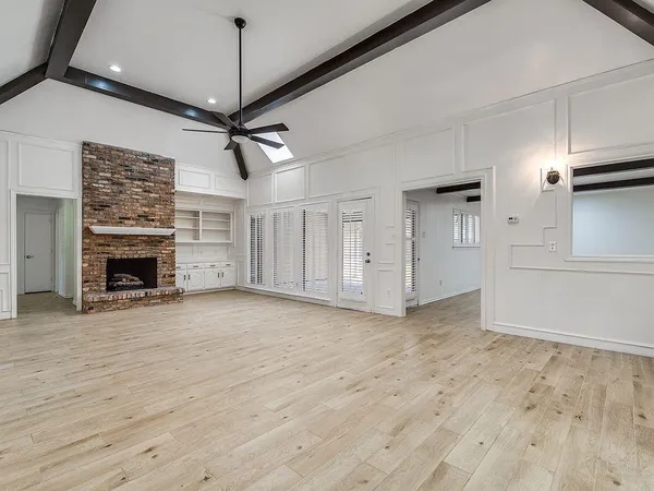 a view of a livingroom with an empty space and a fireplace