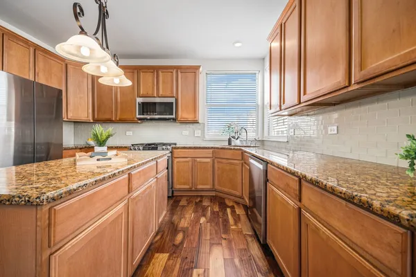 a kitchen with a sink stove and cabinets