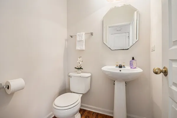 a bathroom with a toilet sink and mirror