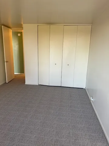 a white toilet sitting next to a shower curtain