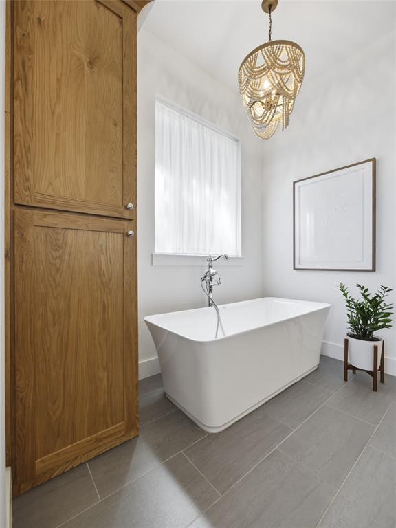 4211 Azalea Way Midlothian, TX 76065 - Photo 22 of 39 Freestanding soaking tub with chrome fixtures, complemented by a beaded chandelier