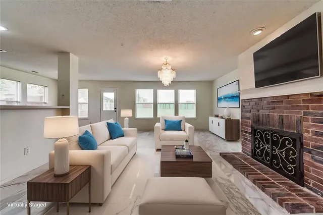 a living room with fireplace furniture and a flat screen tv