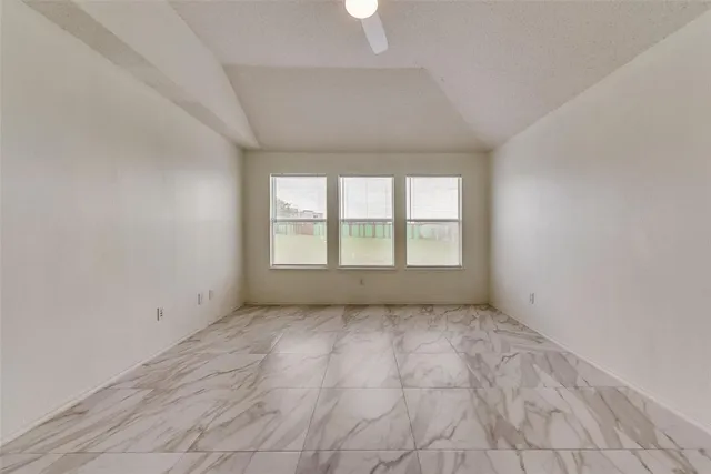 an empty room with a empty space and windows