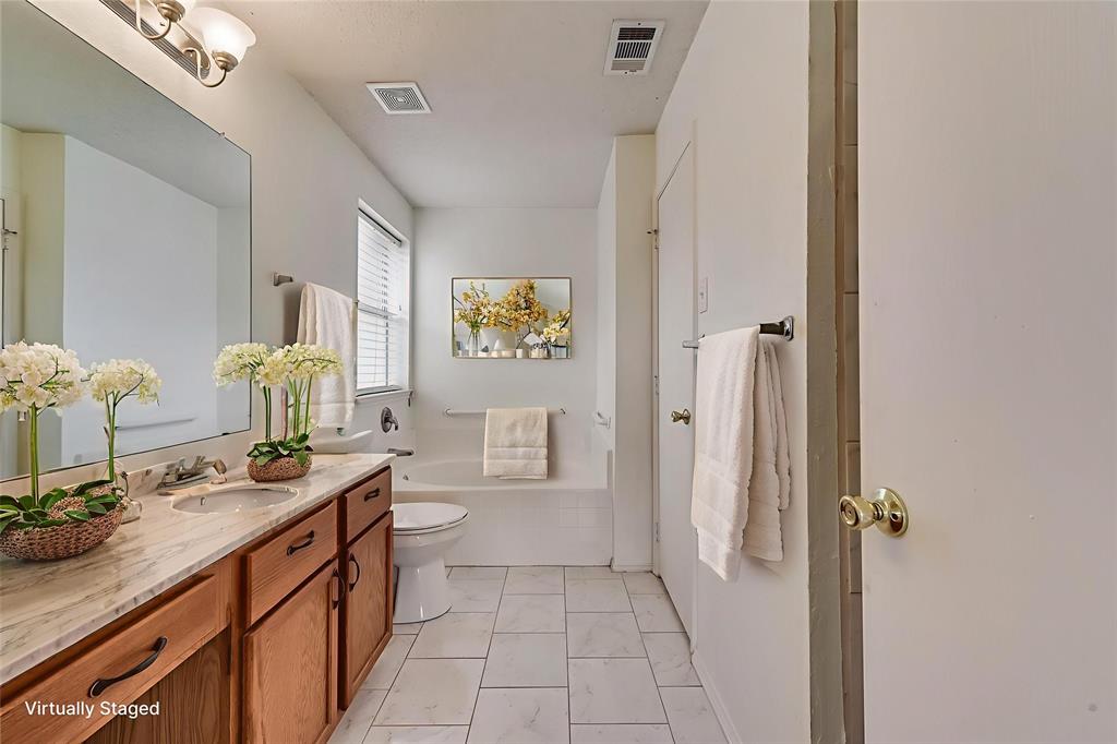 13401 Ponderosa Ranch Road Fort Worth, TX 76262 - Photo 6 of 22 a bathroom with a double vanity sink mirror and toilet