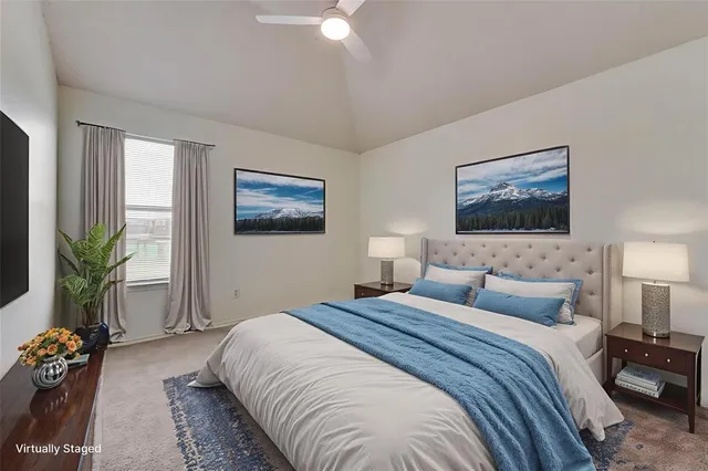 a bedroom with a bed and a potted plant