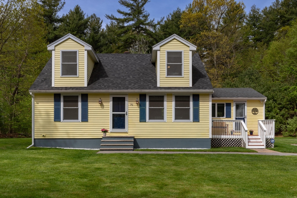 70 Parham Road Tyngsboro, MA 01879 - Photo 1 of 40 a front view of a house with a garden