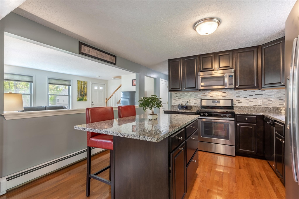 70 Parham Road Tyngsboro, MA 01879 - Photo 14 of 40 a kitchen with stainless steel appliances granite countertop a sink stove and refrigerator