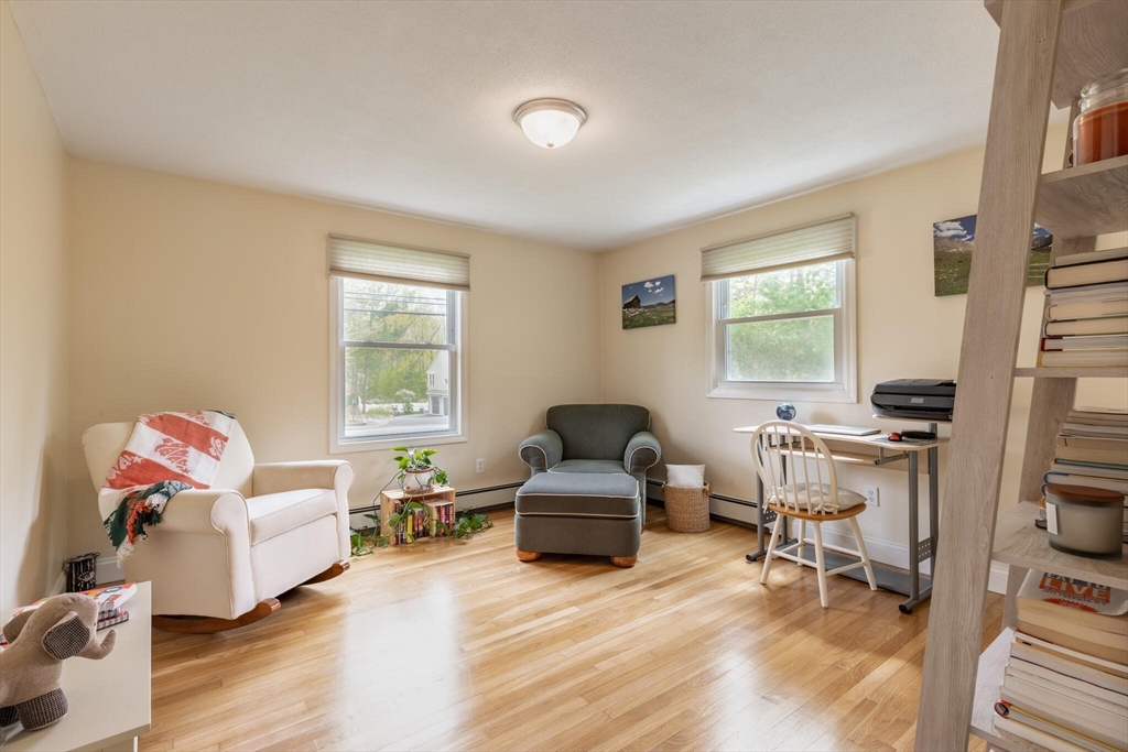 70 Parham Road Tyngsboro, MA 01879 - Photo 24 of 40 a living room with furniture a window and a flat screen tv