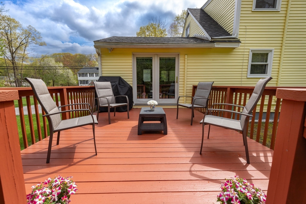 70 Parham Road Tyngsboro, MA 01879 - Photo 34 of 40 a view of a roof deck with table and chairs a barbeque with wooden floor and fence