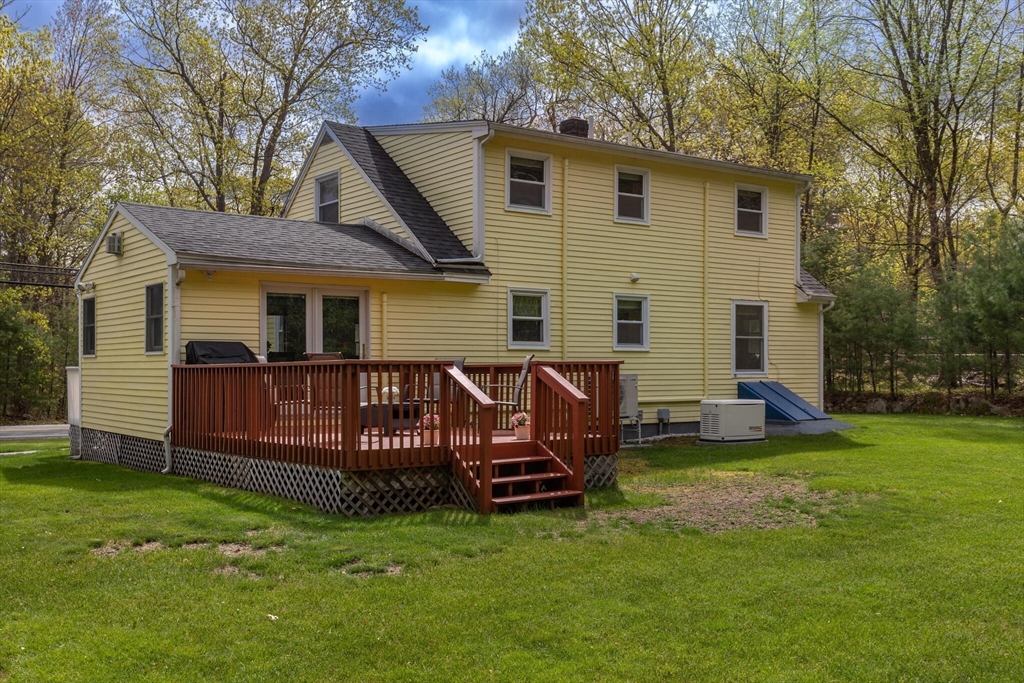 70 Parham Road Tyngsboro, MA 01879 - Photo 36 of 40 a view of a house with a yard and sitting area