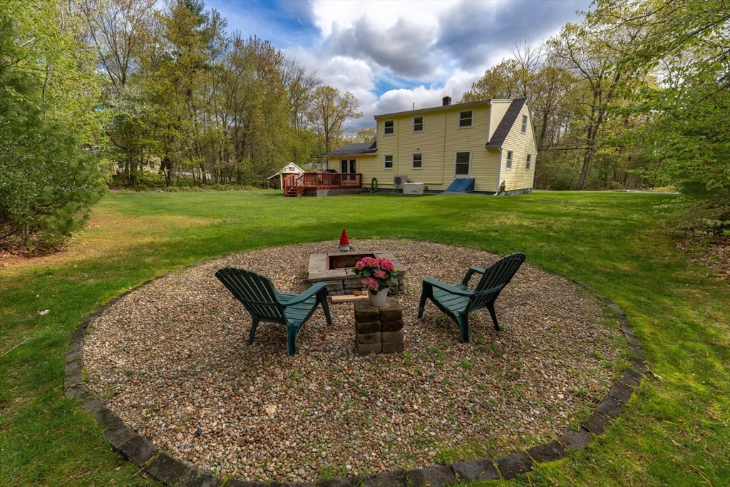 70 Parham Road Tyngsboro, MA 01879 - Photo 39 of 40 a view of a patio with table and chairs with wooden fence