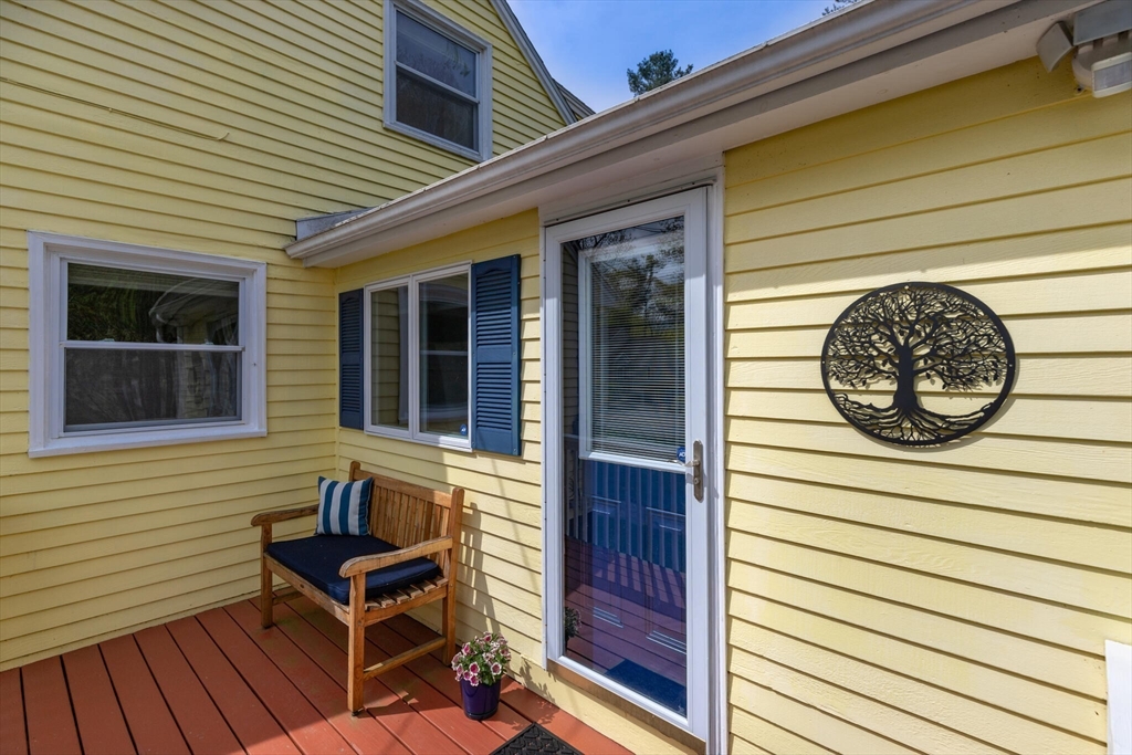 70 Parham Road Tyngsboro, MA 01879 - Photo 4 of 40 a view of a house with wooden door and a bench