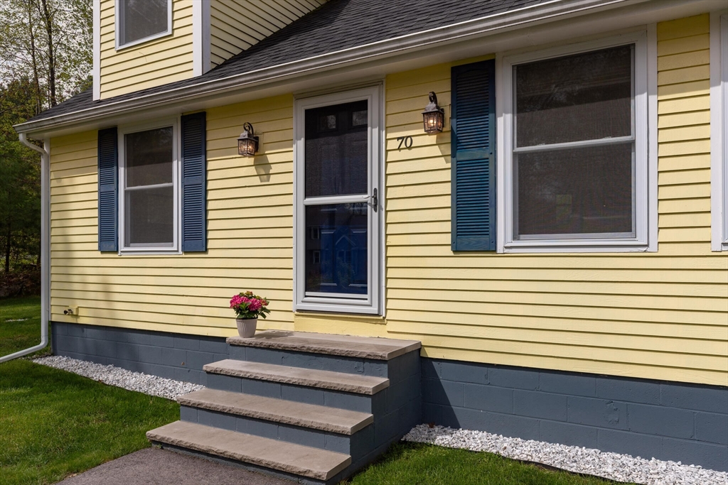 70 Parham Road Tyngsboro, MA 01879 - Photo 5 of 40 a front view of a house with a yard