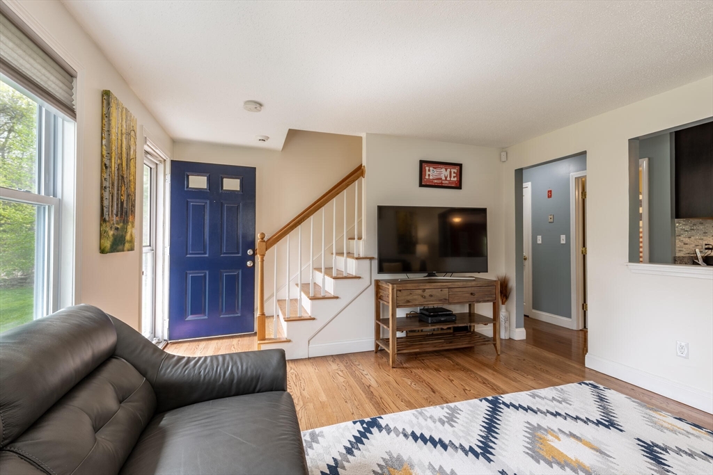 70 Parham Road Tyngsboro, MA 01879 - Photo 10 of 40 a living room with furniture and a flat screen tv