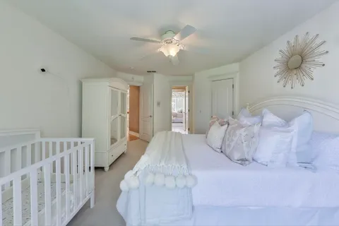 a bedroom with a bed and a chandelier