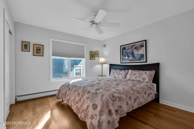 a bedroom with a bed a couch and a window