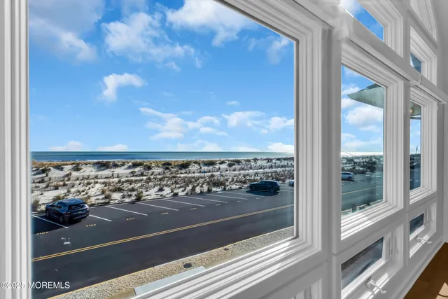 a balcony with a large window and wooden floor