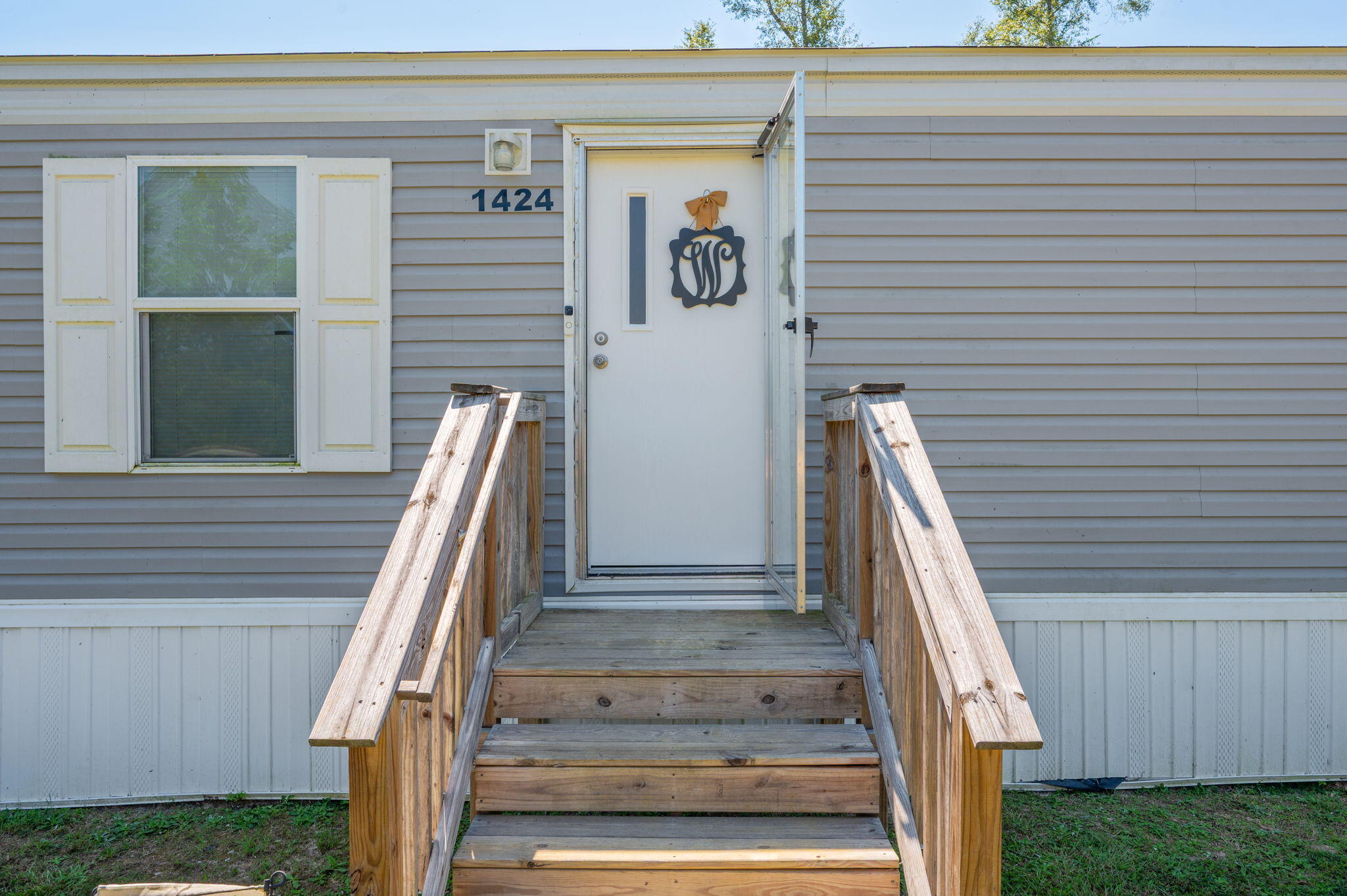 a view of staircase with white walls and railing