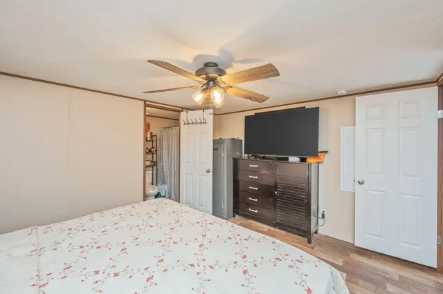 a bedroom with a bed and a flat screen tv