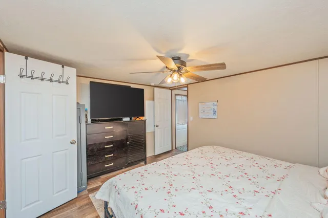 a bedroom with a bed and a flat screen tv