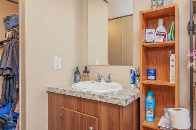 a bathroom with a stove a sink and a painting on the wall