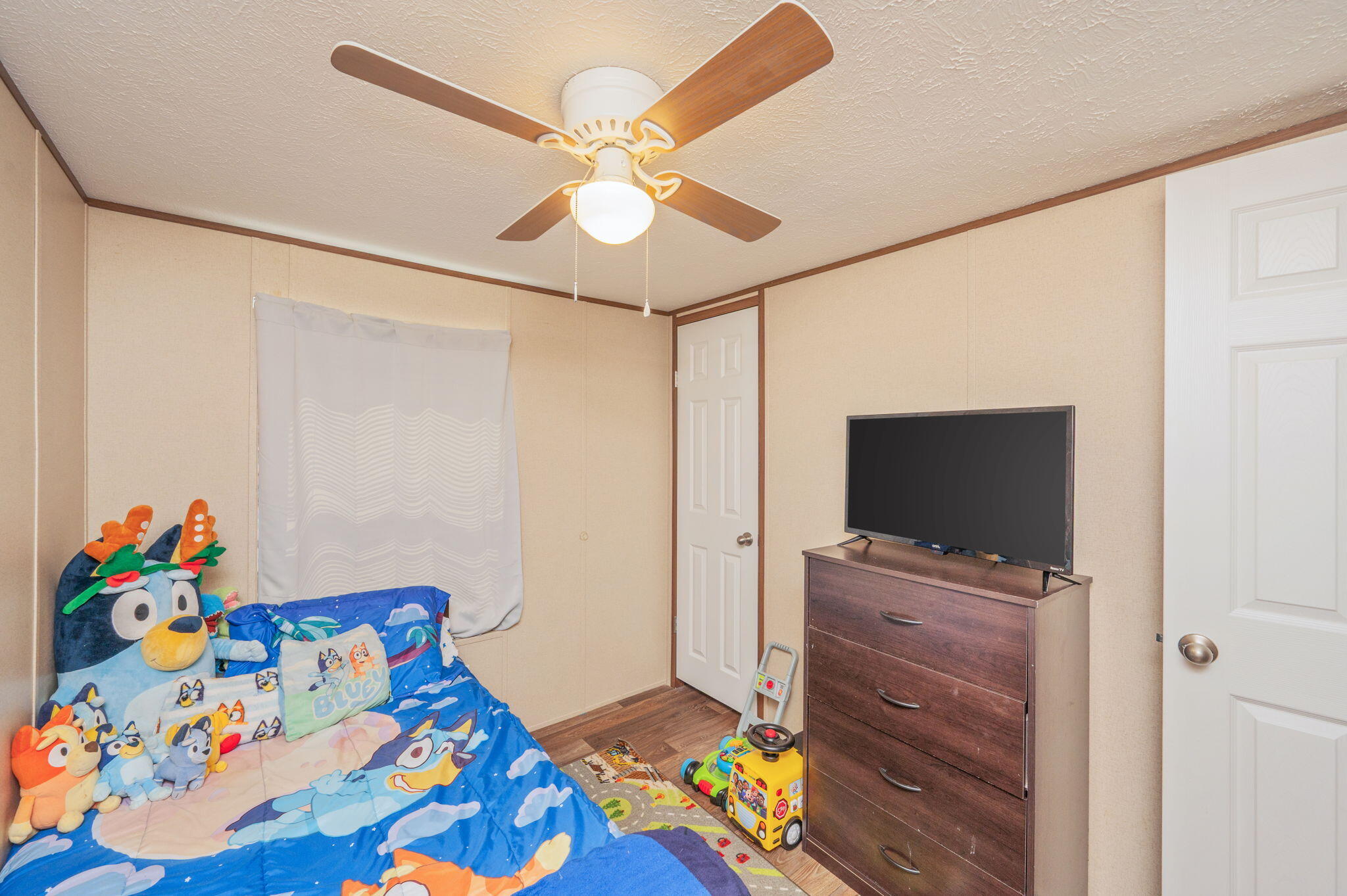 1424 East F Sanford Road Baker, FL 32531 - Photo 17 of 32 a bedroom with a bed and a flat screen tv