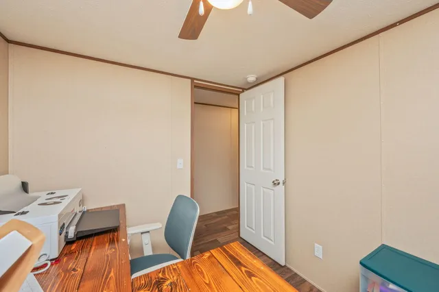 a view of a room with wooden floor and furniture
