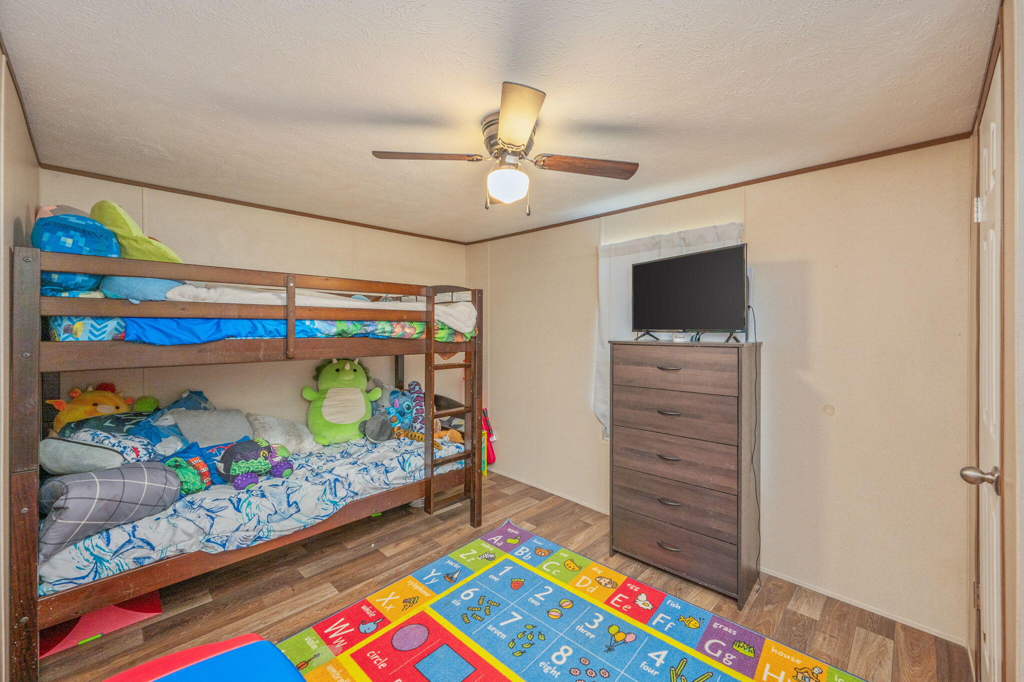 1424 East F Sanford Road Baker, FL 32531 - Photo 21 of 32 a room with painting on the wall and a couch