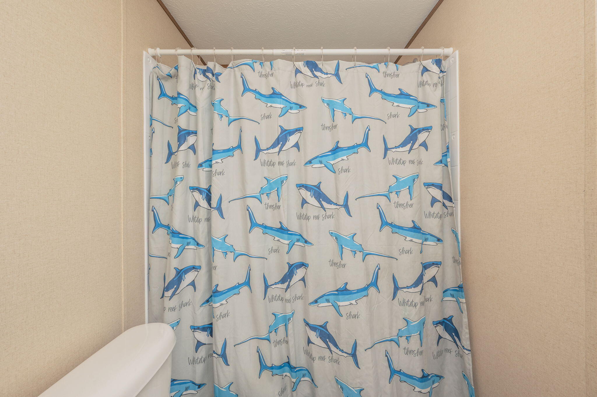 1424 East F Sanford Road Baker, FL 32531 - Photo 23 of 32 a white toilet sitting next to a shower curtain