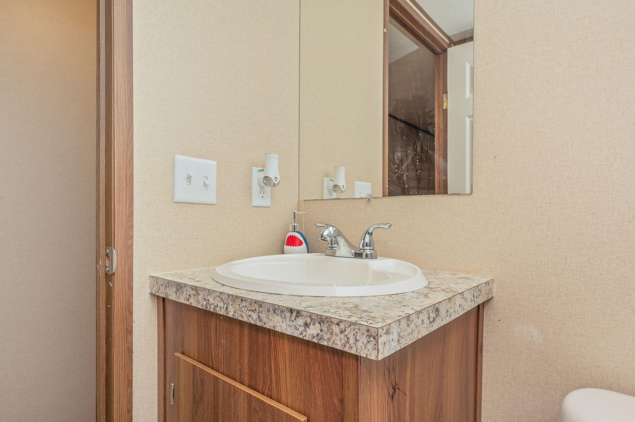 1424 East F Sanford Road Baker, FL 32531 - Photo 24 of 32 a bathroom with a sink and a mirror