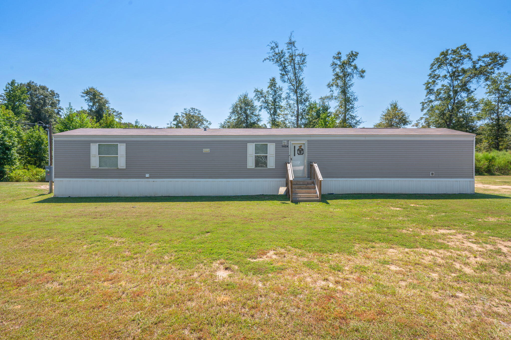 1424 East F Sanford Road Baker, FL 32531 - Photo 26 of 32 a view of a swimming pool with an outdoor space and seating area