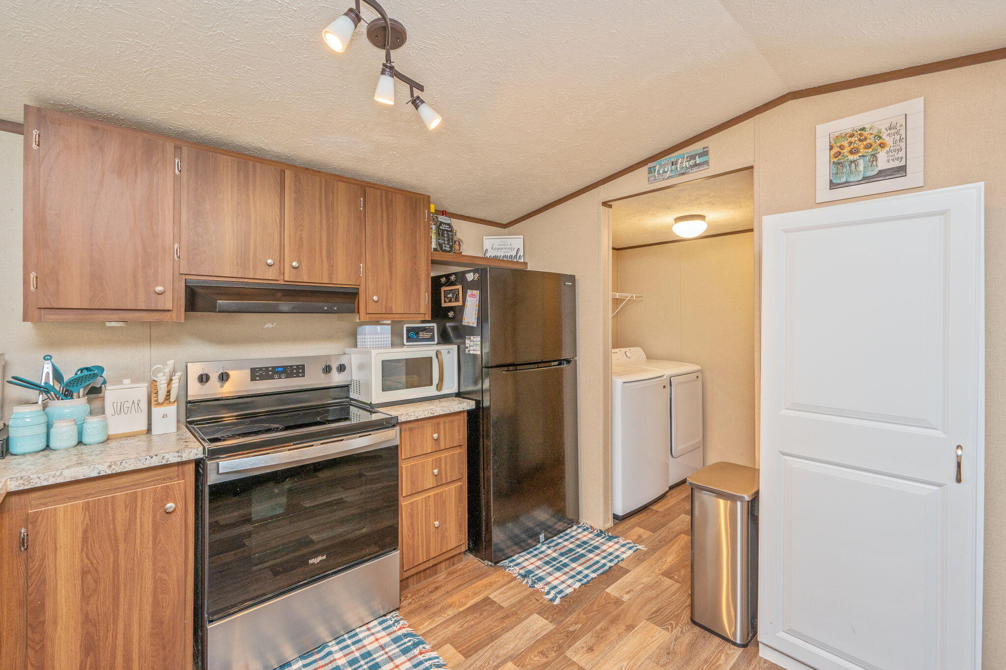 1424 East F Sanford Road Baker, FL 32531 - Photo 6 of 32 a kitchen with a refrigerator and a stove top oven